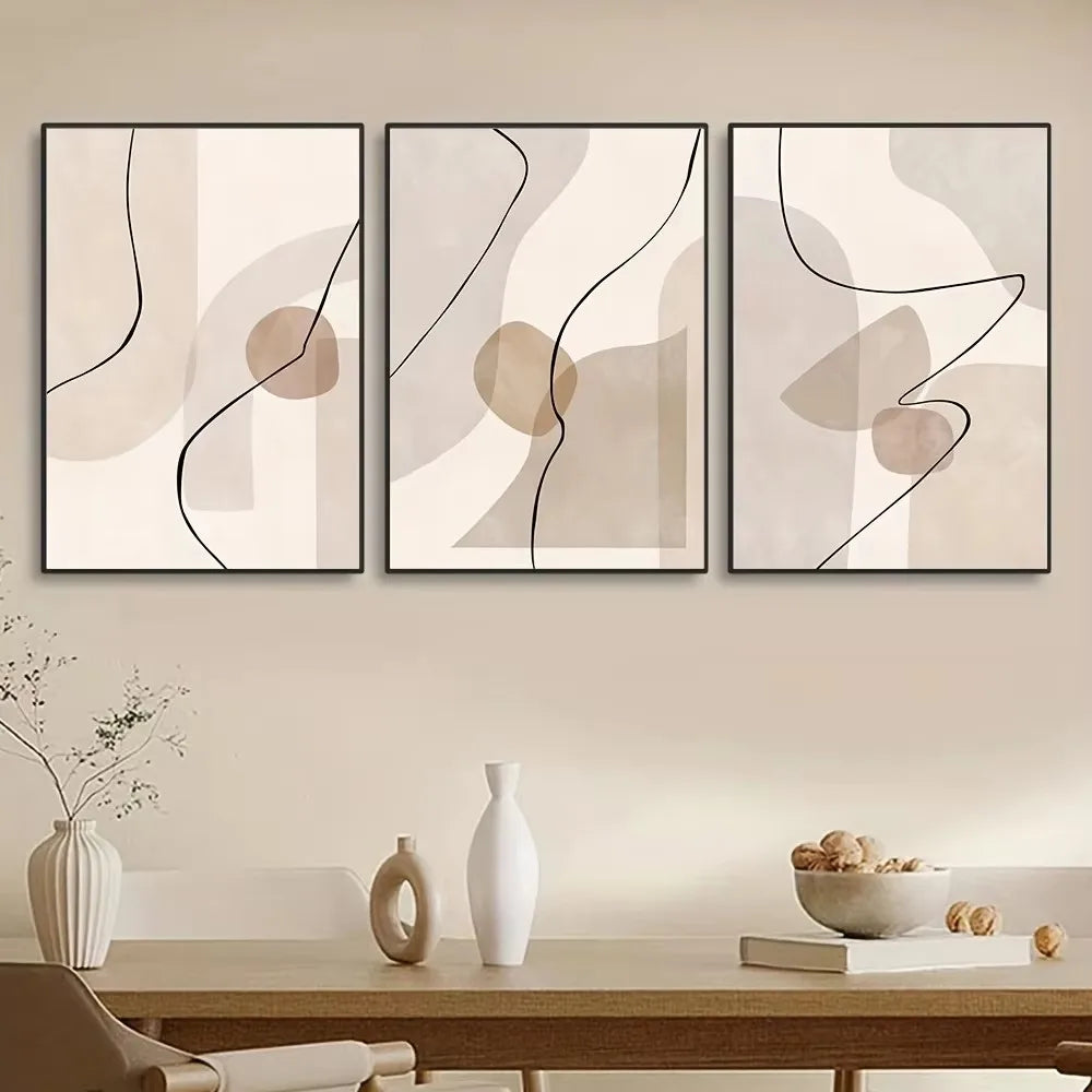 Three abstract wall art pieces on a wall above a table with decorative items.