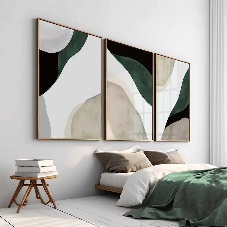 Three abstract wall art pieces in a modern bedroom setting.
