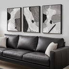 Gray leather sofa with abstract art on a wall