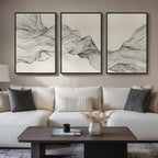 Living room with a white sofa, wooden coffee table, and abstract wall art.