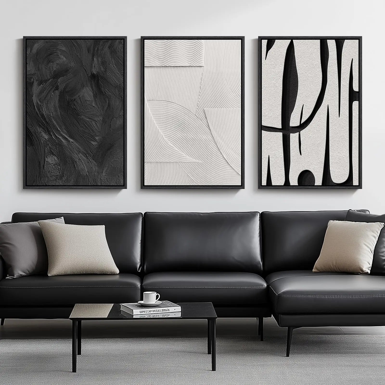 Modern living room with a black leather sofa and abstract art on the wall.