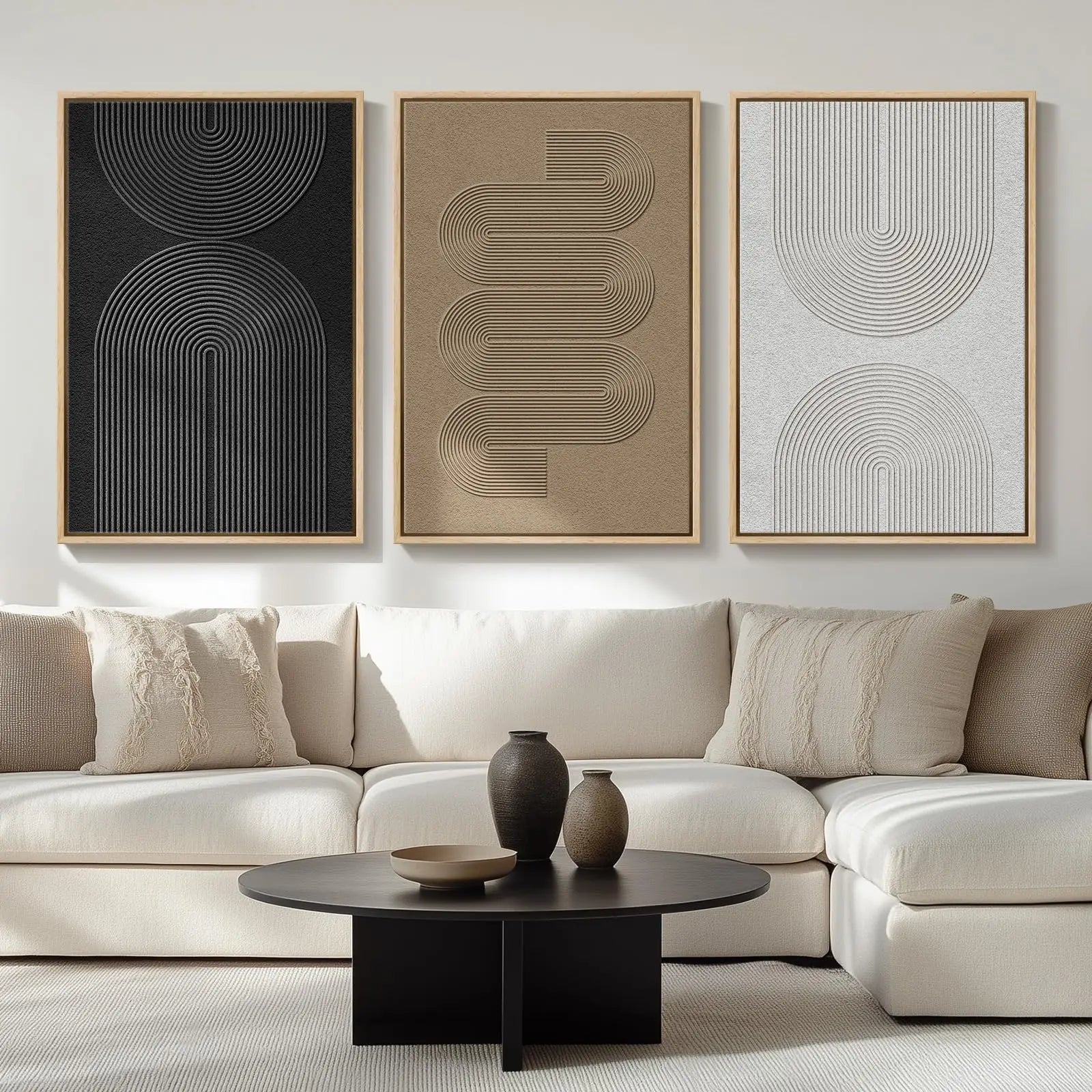 Modern living room with a white sofa, black coffee table, and abstract wall art.
