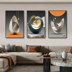 Three abstract art pieces on a wall above a sofa in a living room.