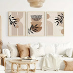 Living room with a white sofa, decorative pillows, and wall art featuring abstract designs.