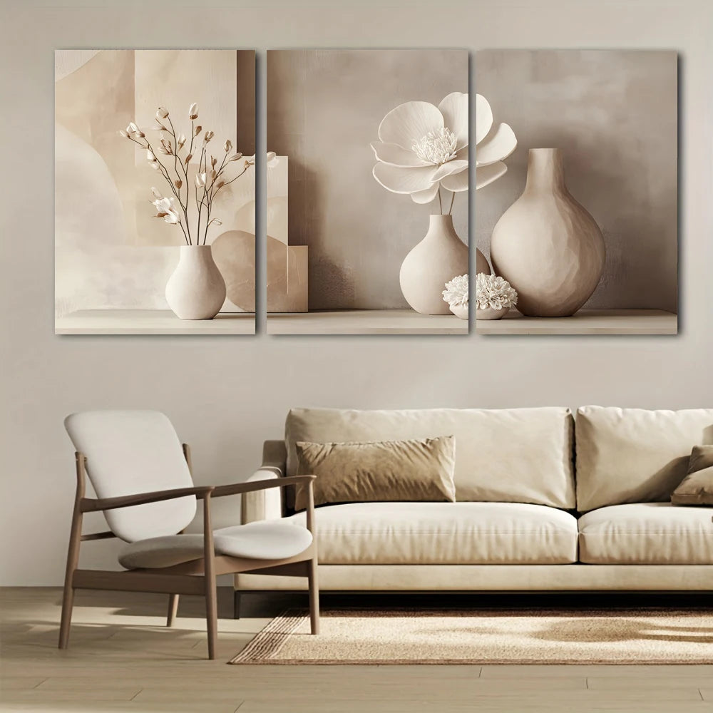 Three abstract wall art pieces above a beige sofa and chair in a living room.