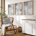 Living room with wicker chair, white cabinet, and abstract wall art