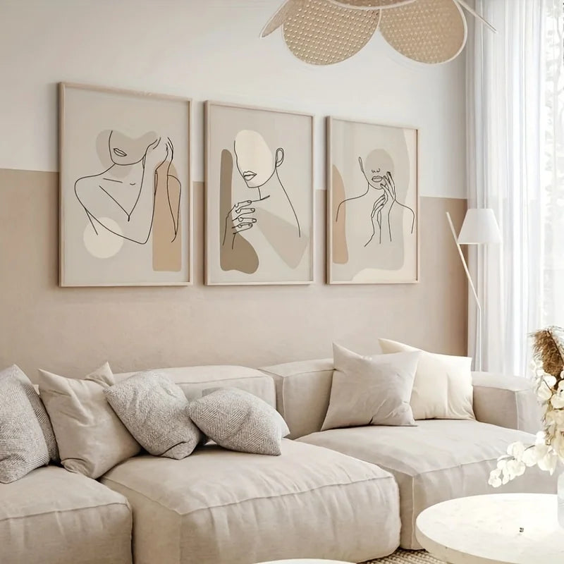 Beige living room with a sofa, decorative pillows, and wall art.