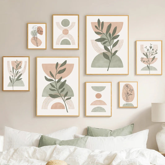 Set of botanical wall art prints on a neutral wall above a bed.