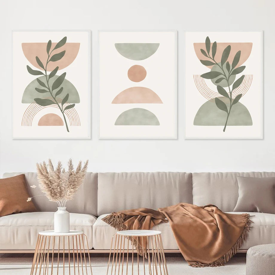 Three abstract art prints in a living room setting with a sofa and decor.