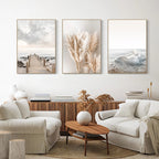 Living room with white sofas, a wooden coffee table, and wall art depicting nature.