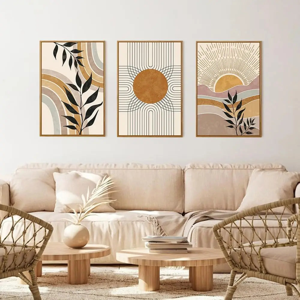 Three abstract art pieces on a wall above a beige sofa in a living room.