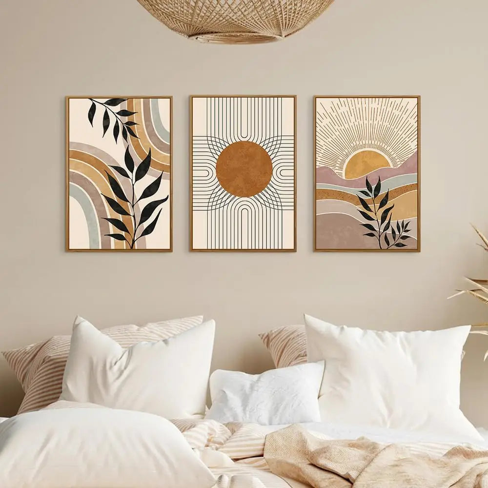 Three abstract wall art pieces on a wall above a bed with neutral tones.