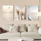 Three coastal-themed wall art pieces above a sofa in a living room.
