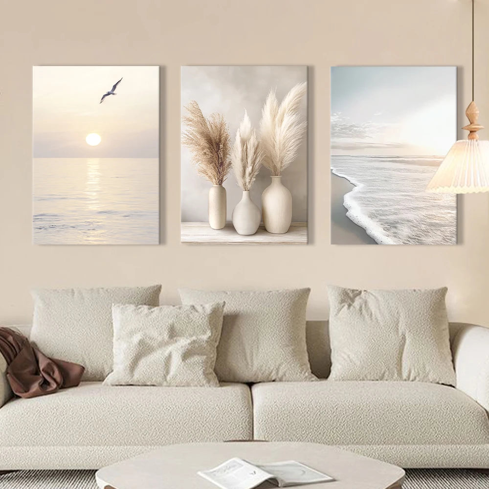 Three coastal-themed wall art pieces above a sofa in a living room.