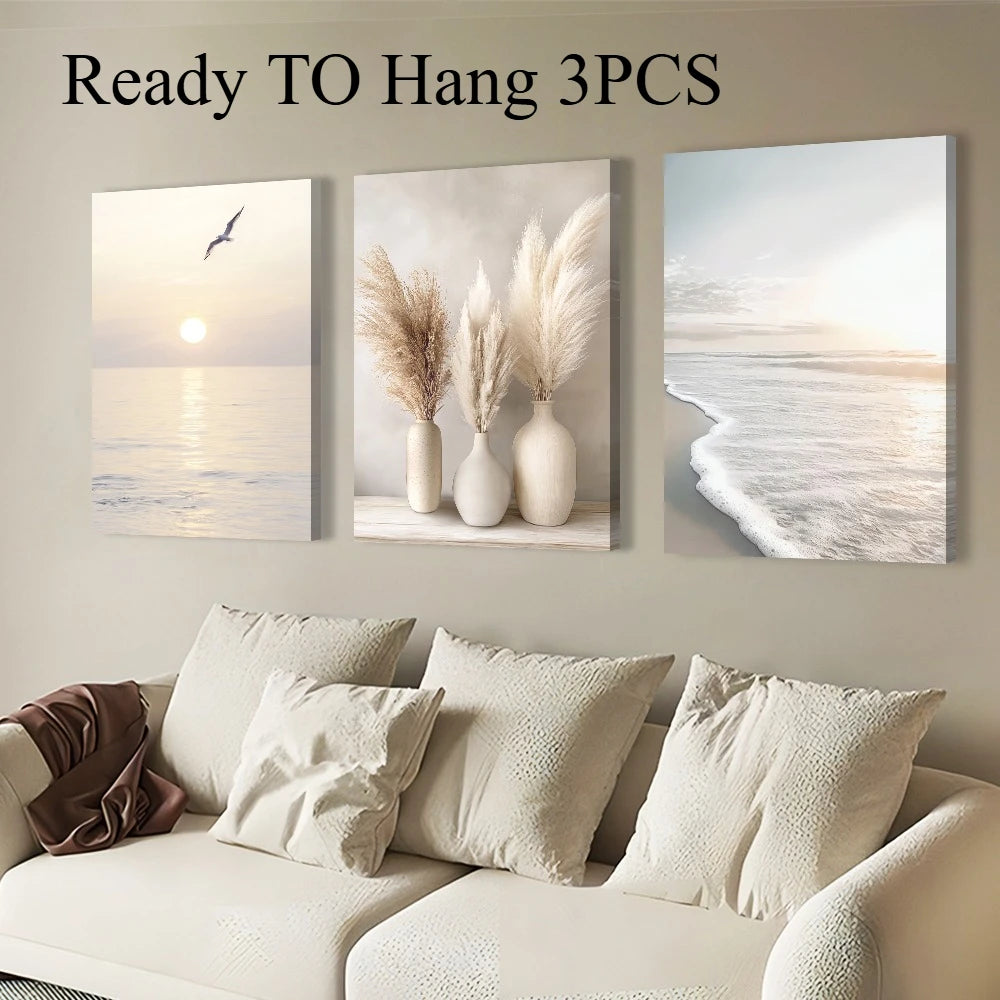 Three wall art pieces above a sofa with neutral tones.