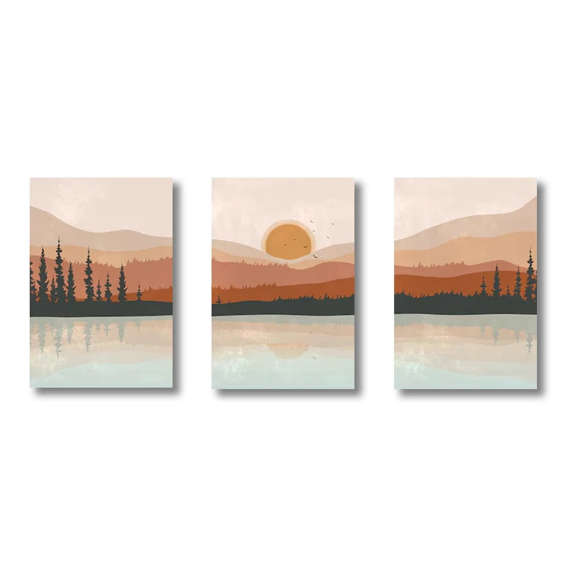 Set of three wall art prints depicting a sunset over a lake with mountains and trees.