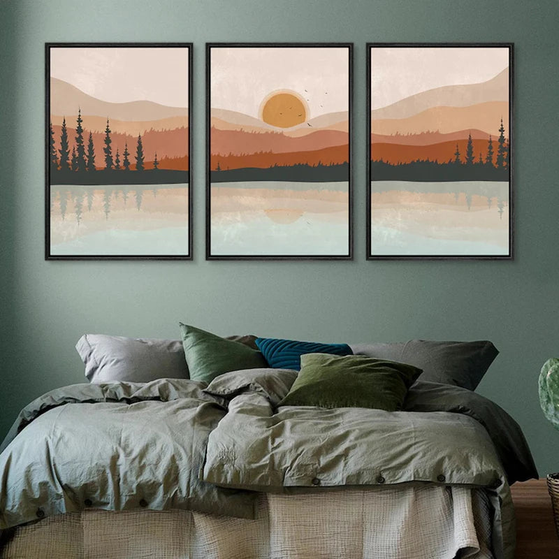 Three framed landscape prints above a bed with green walls