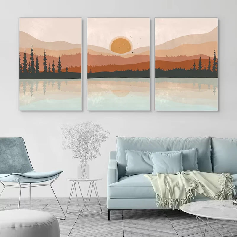 Three landscape paintings above a light blue sofa in a living room.