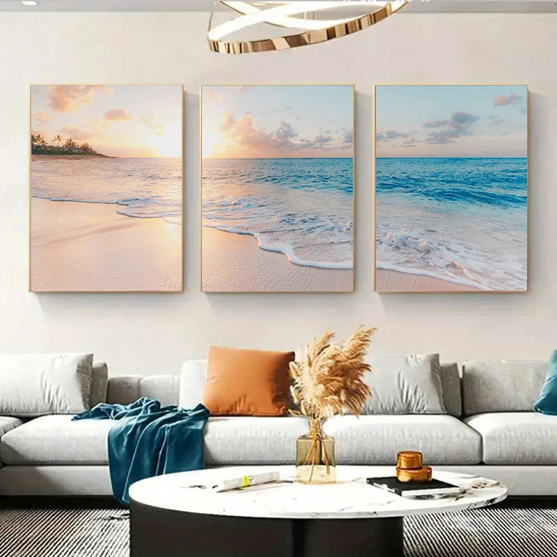 Three beach-themed wall art pieces above a sofa in a living room.