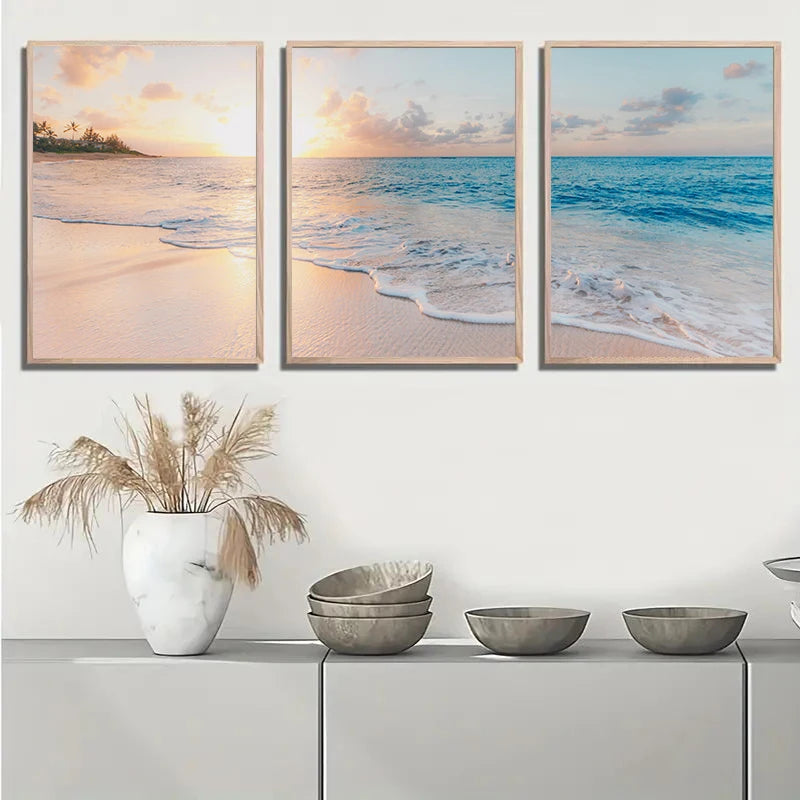 Three framed beachscape artworks above a shelf with decorative items.