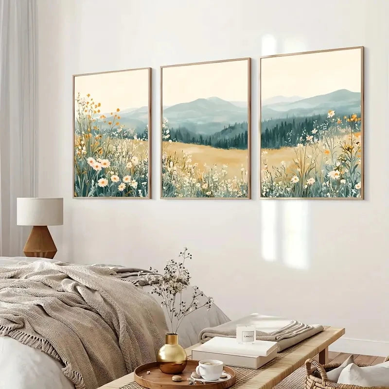 Three framed landscape paintings of fields and mountains in a bedroom setting.