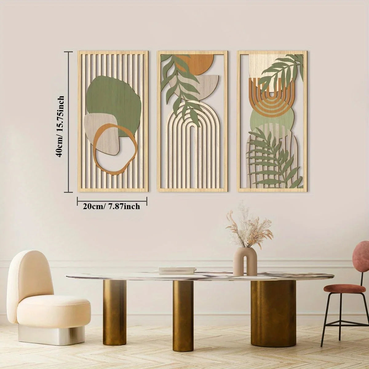 Three abstract wall art pieces with green and brown tones on a beige wall above a dining table.