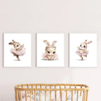 Three framed illustrations of a bunny in a tutu on a wall above a crib.