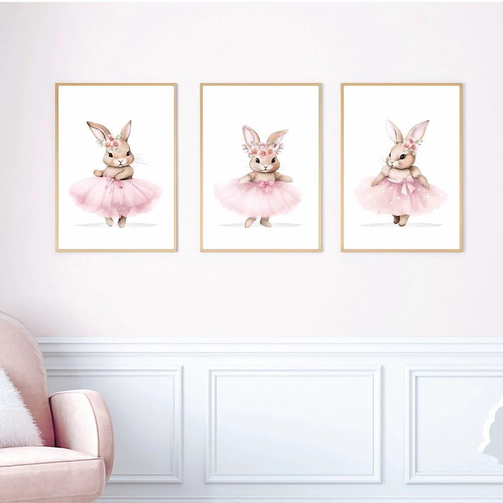 Three framed illustrations of rabbits in ballet costumes on a white wall.