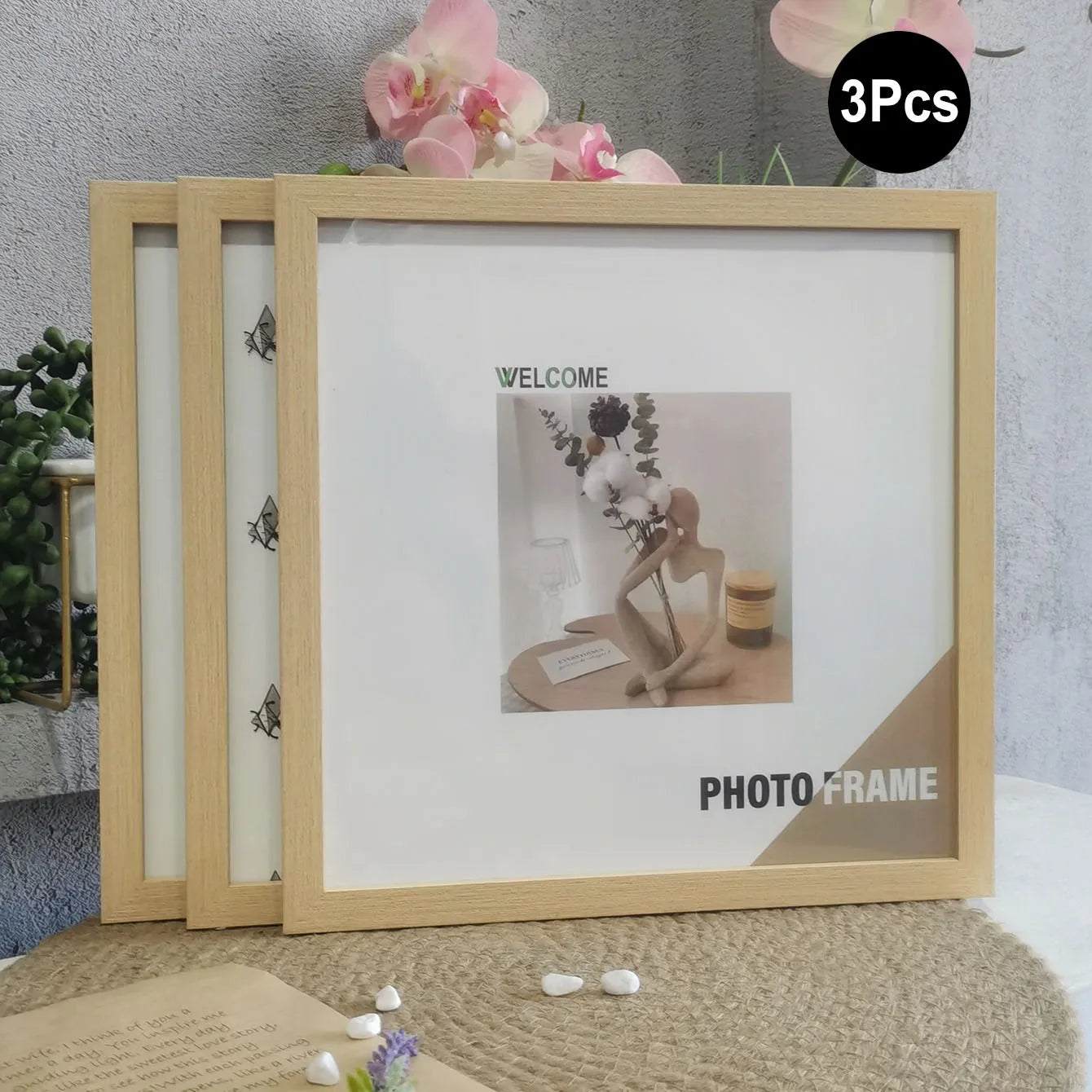 Three wooden photo frames with a decorative photo on a textured surface.