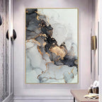 Abstract art piece with gold and black accents in a modern interior setting.