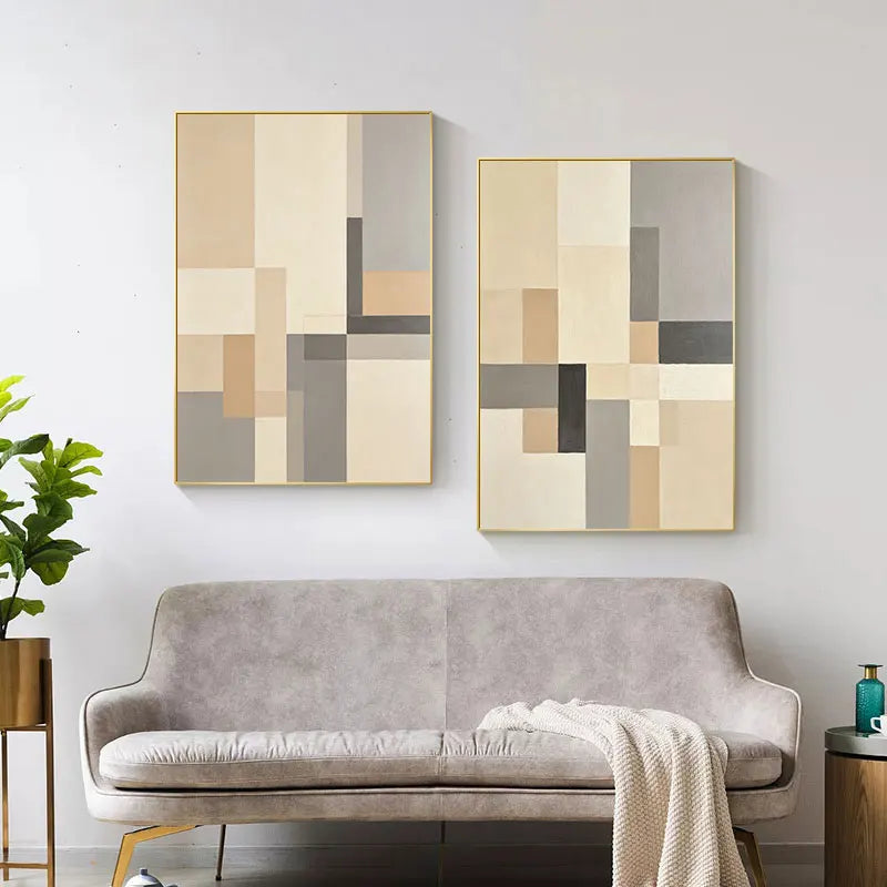 Two abstract wall art pieces above a sofa in a living room setting.