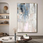 Abstract painting in a modern living room setting with decor elements.