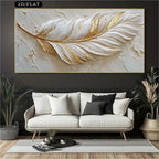 Decorative wall art of a gold feather on a textured background above a white sofa.