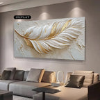 Decorative wall art of a feather with gold accents in a living room setting.