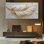 Decorative wall art of a feather with gold and white colors in a modern living room.