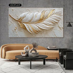 Decorative wall art of a gold and white feather on a gray wall above a modern living room setup.