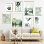 Living room with a beige sofa, decorative pillows, and wall art featuring green and white abstract designs.