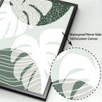 Framed botanical art with leaf pattern on a white background, highlighting waterproof and cotton canvas qualities.