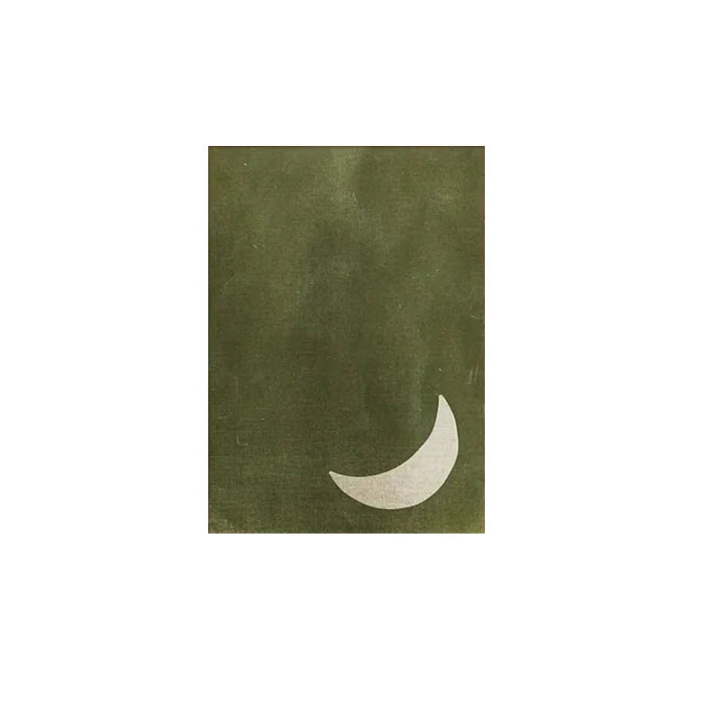 Green notebook with a white crescent moon design on a white background