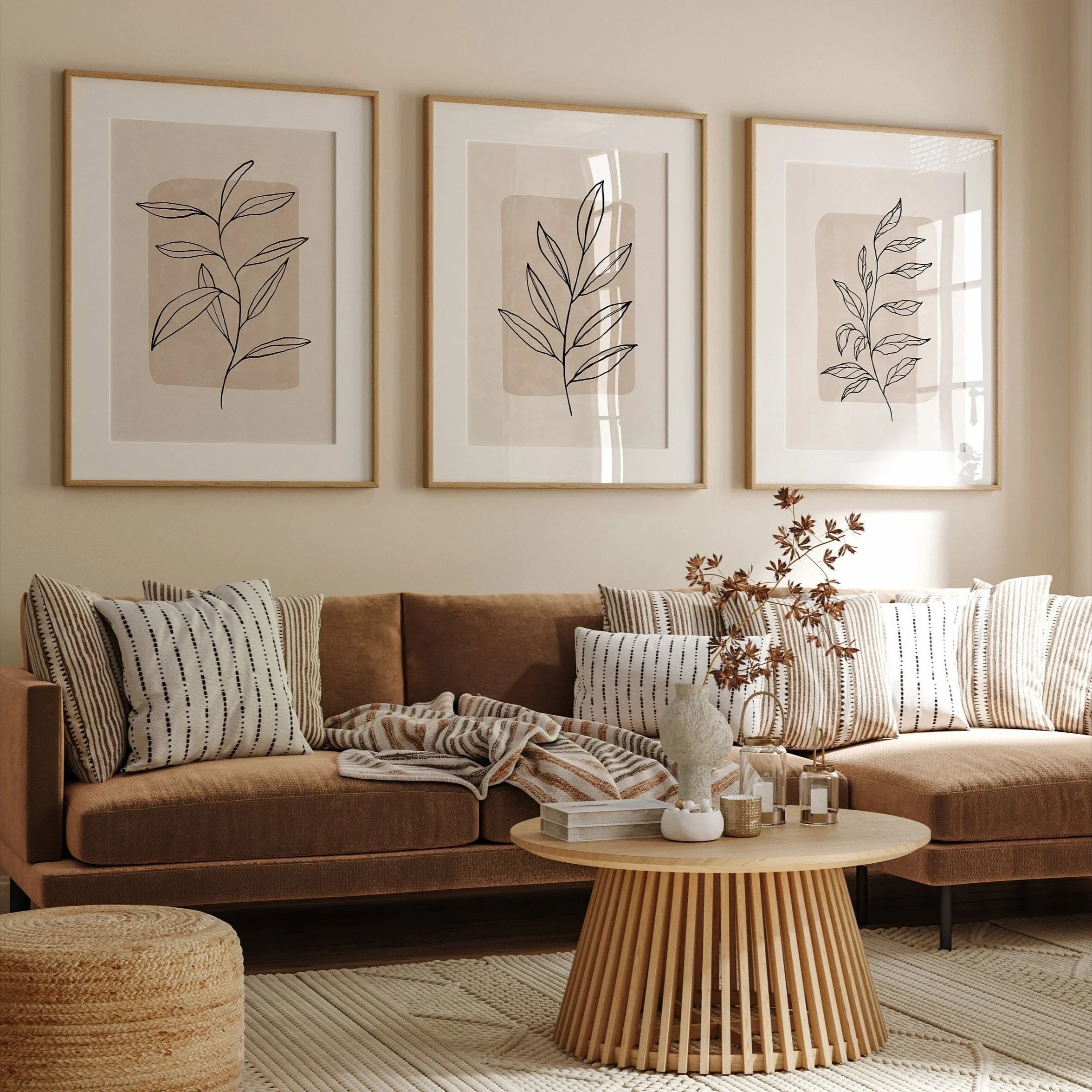 Living room with a brown sectional sofa, round wooden coffee table, and wall art.