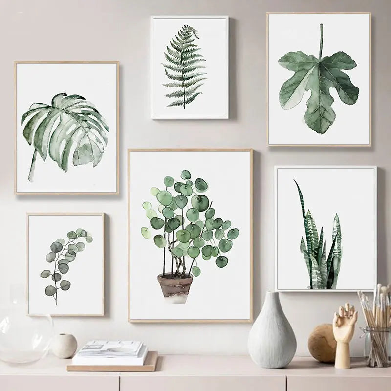 Set of framed botanical prints on a wall with decorative items below.
