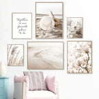 Wall with framed artwork including beach scene, floral, and nature-themed prints.