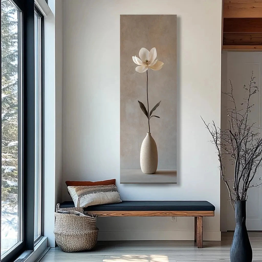 Modern interior with a large wall art of a white flower in a vase, a bench, and decorative items.