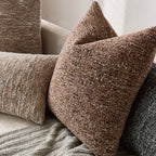 Textured brown pillow on a sofa with neutral background
