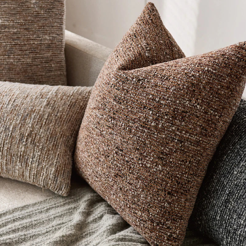 Textured brown pillow on a sofa with neutral background