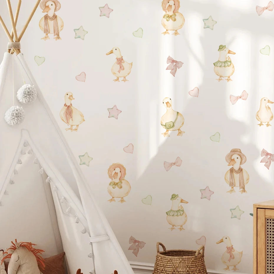 Children's room with decorative wall stickers of ducks, stars, and hearts on a white wall.