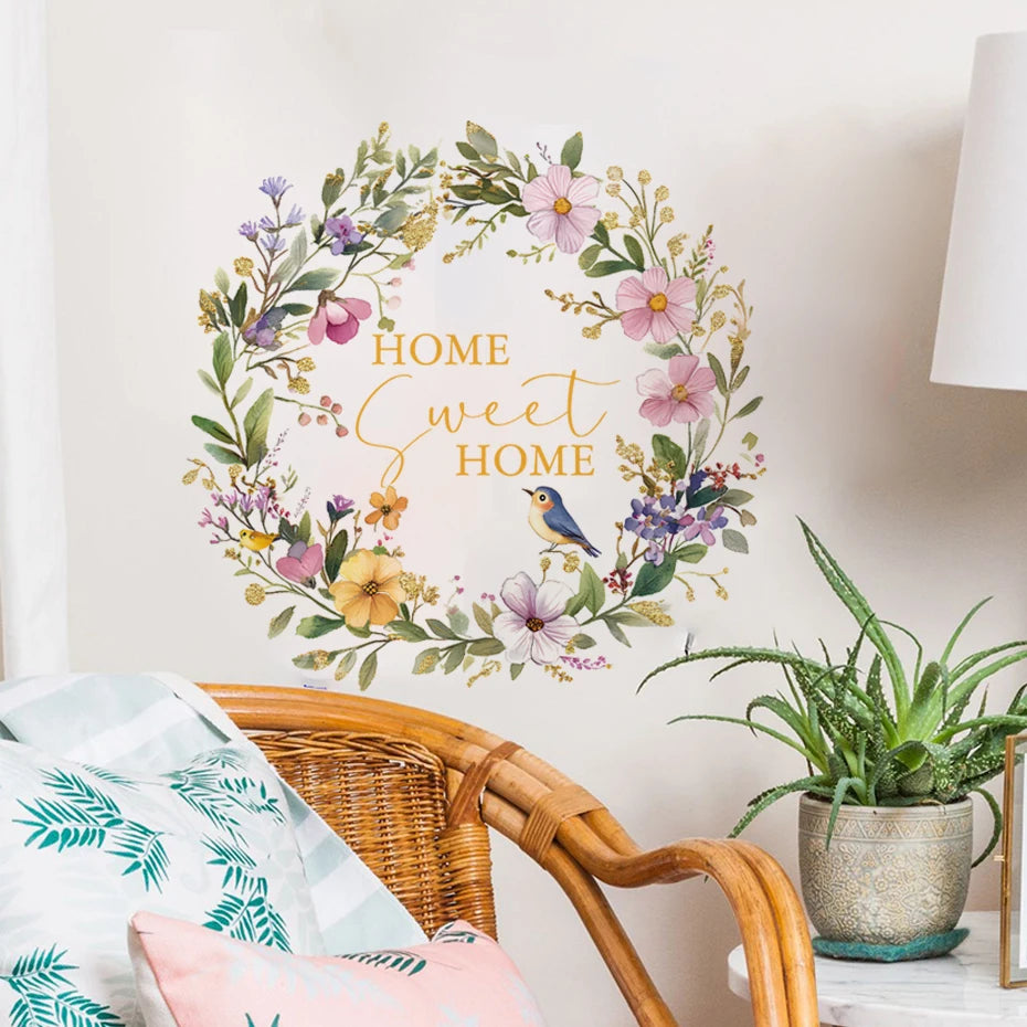 Decorative wall sticker with floral design and 'Home Sweet Home' text in a living room setting.