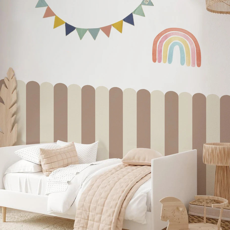 Children's bedroom with striped headboard, rainbow decoration, and colorful banner.
