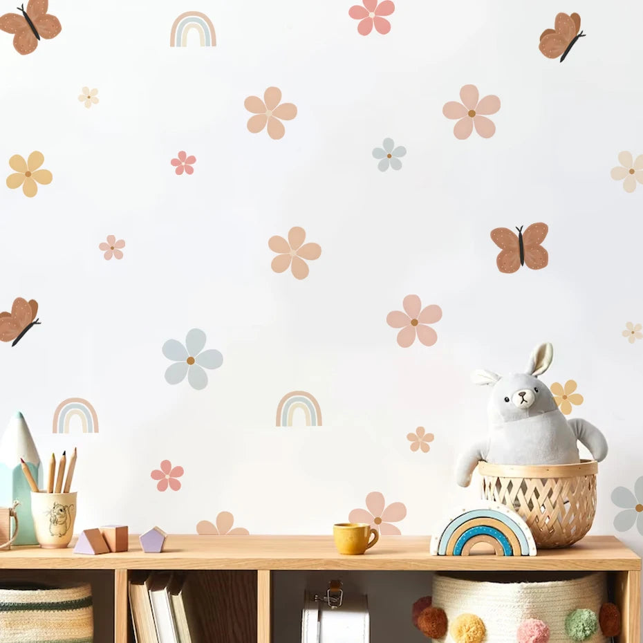Children's room with decorative wall stickers, a plush toy, and stationery items on a shelf.