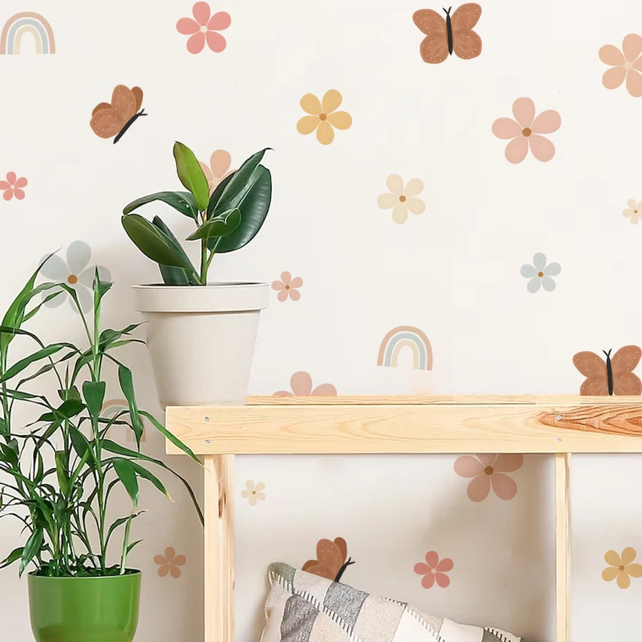 Children's room with wooden shelf, potted plants, and decorative wall stickers.